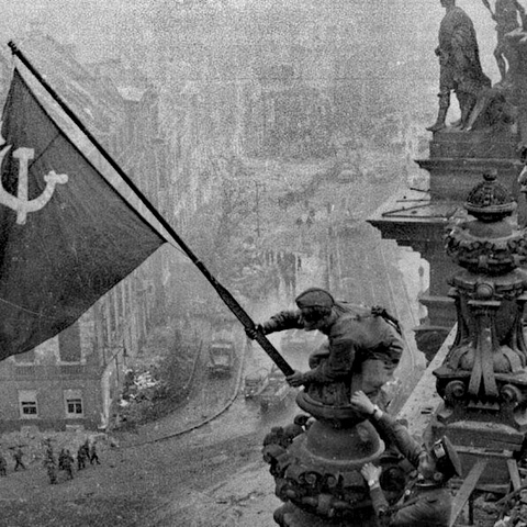Raising a Flag over the Reichstag by Yevgeny Khaldei (1945).