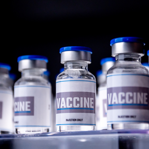 glass vaccine vials with labels that read "vaccine"